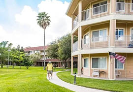 A man and woman walking on a sidewalk in front of a building. AI generated content